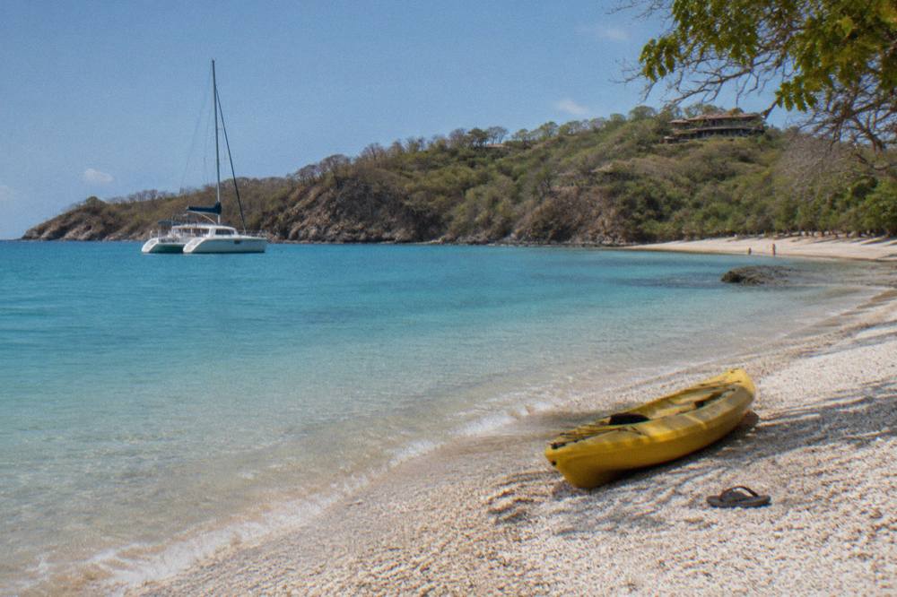 Anchored catamaran in a calm bay near Tamarindo with clear turquoise water