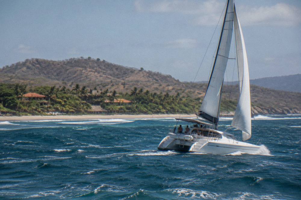 A private catamaran under sail on open water off the Guanacaste coast